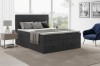 Stilvolles anthrazitfarbenes Boxspringbett aus Cord in modernem Schlafzimmer.