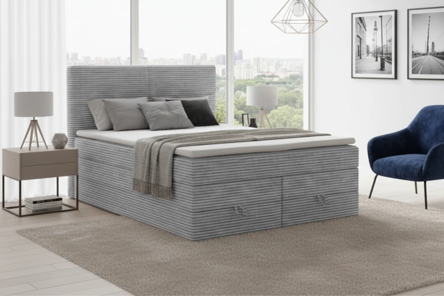 Modernes Boxspringbett in Grau mit Cord-Bezug und Bettkasten im hellen Schlafzimmer.