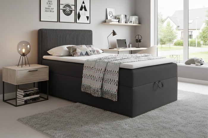 Stijlvolle tienerkamer met modern antracietkleurig boxspringbed en decoratie.