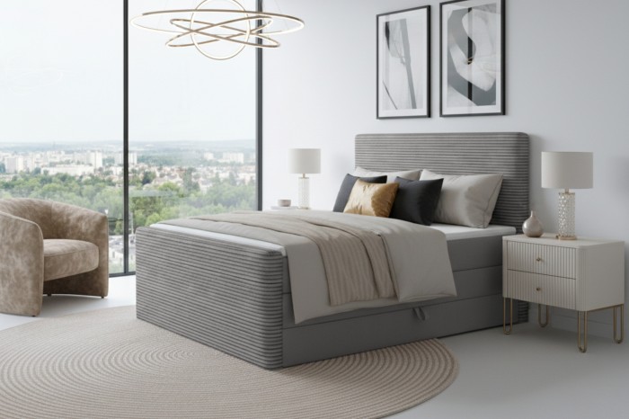 Stijlvol grijs boxspringbed met cord-bekleding in een moderne slaapkamer met uitzicht.