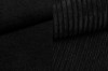 Texture detail of black corduroy fabric for modern upholstered furniture and beds.