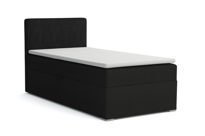 Schwarzes Boxspringbett mit geripptem Kopfteil und weißer Matratze.