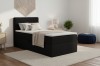 Schwarzes Boxspringbett im modern eingerichteten Schlafzimmer mit Deko.