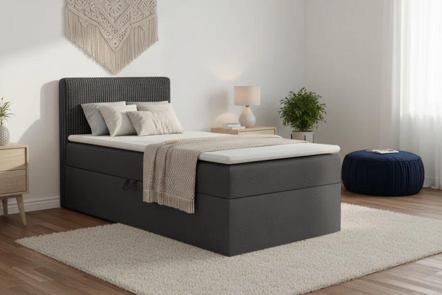 Modernes Boxspringbett in Anthrazit mit Cord-Kopfteil und weißem Topper.