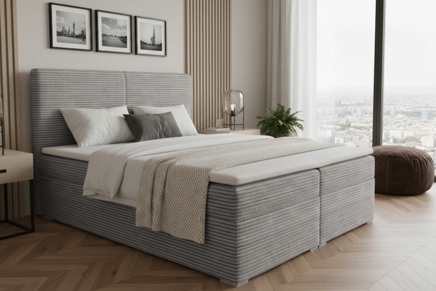 Modernes Boxspringbett in Grau aus Cordstoff im Schlafzimmer mit Stadtblick.