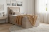 Beiges Boxspringbett mit Stauraum, weißem Topper und gelber Decke im modernen Schlafzimmer.