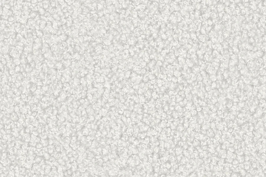 Nahaufnahme der flauschigen Bouclé-Struktur des Sofa-Bezugstoffs in Weiß.