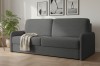 Dunkelgraues Polstersofa in gemütlicher Wohnzimmer-Atmosphäre