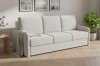 Modernes beige Dreisitzer-Sofa in einem hellen Wohnzimmer.