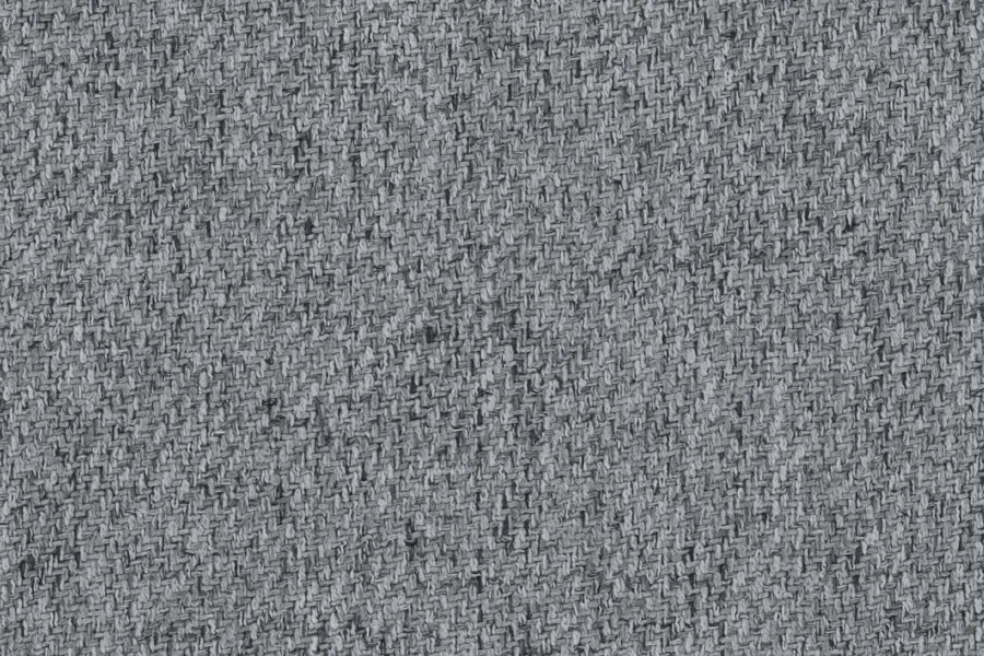 Nahaufnahme der hellgrauen Textilstruktur eines Sofabezugs, hochwertiger Webstoff.