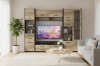 Stilvoll eingerichtetes Wohnzimmer mit großer Wohnwand, Fernseher und grauem Sofa.