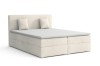 Elegantes Boxspringbett in Creme mit gepolstertem Kopfteil und zwei Kissen vor weißem Hintergrund.