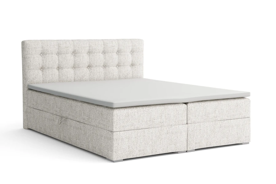 Modernes hellgraues Boxspringbett mit gestepptem Kopfteil und weißem Topper.
