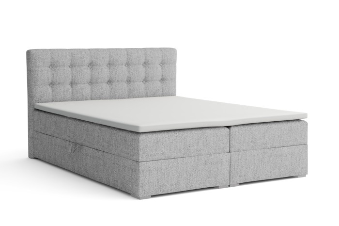Hellgraues Boxspringbett mit gestepptem Kopfteil freigestellt