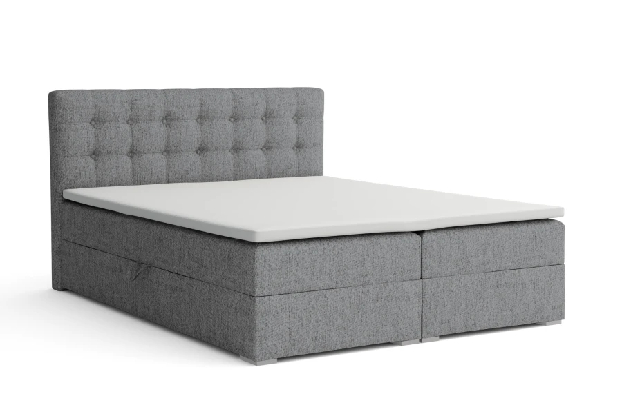 Dunkelgraues Boxspringbett mit Knopfsteppung freigestellt