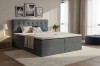 Dunkelgraues Boxspringbett in einem modern eingerichteten Schlafzimmer.