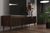 Stilvolles TV-Lowboard aus dunklem Holz mit feiner Riffel-Struktur in einem modernen Raum.