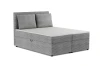 Graues Boxspringbett mit Cord-Bezug, Kopfteil und zwei Kissen.