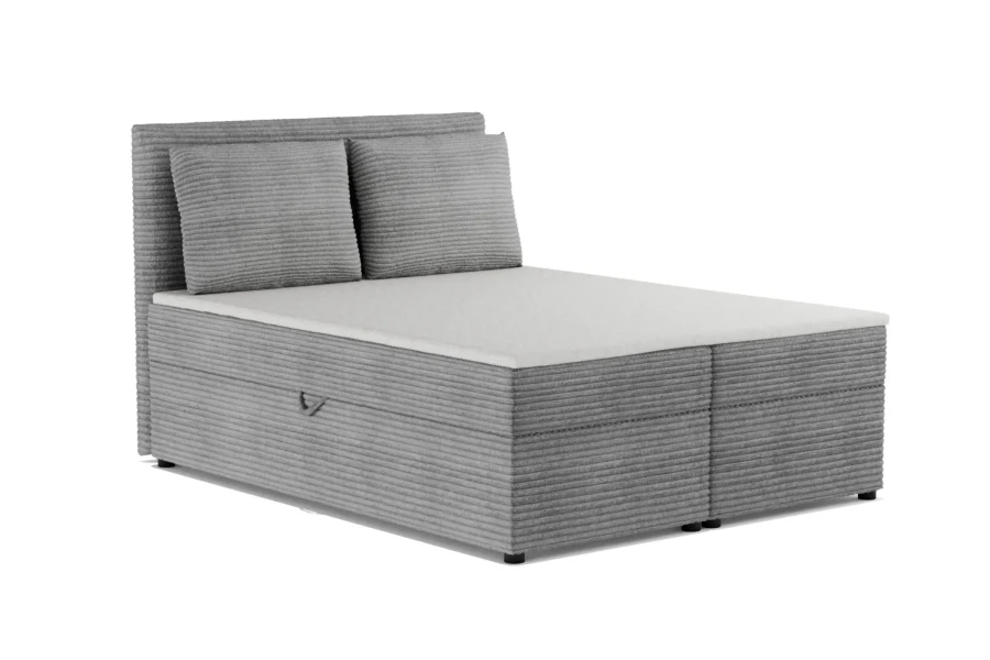 Graues Boxspringbett mit Cord-Bezug, Kopfteil und zwei Kissen.