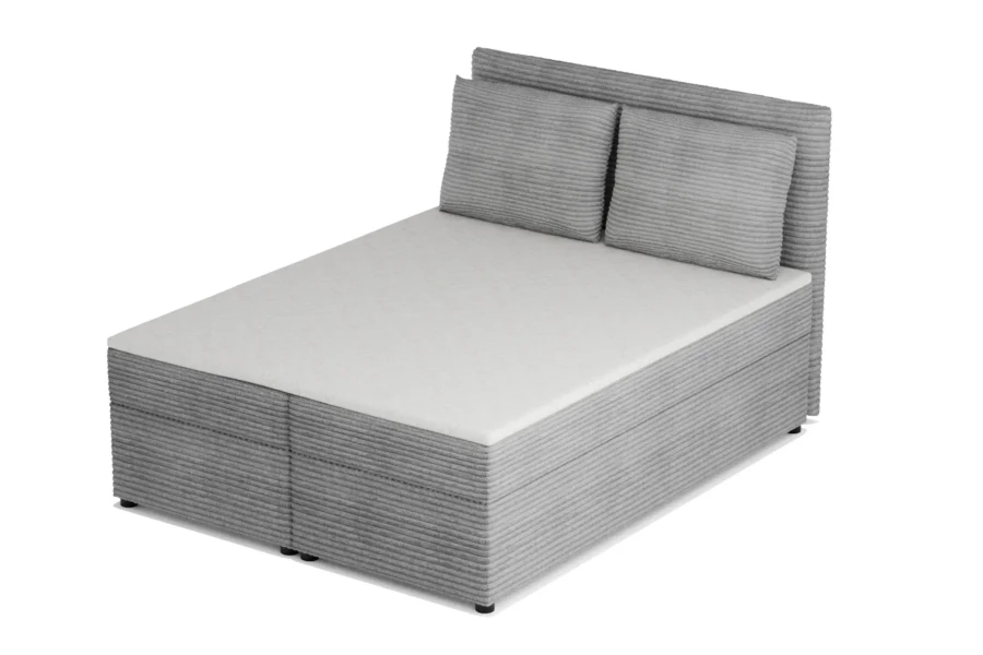 Seitenansicht eines gemütlichen Boxspringbetts in grauem Cord.