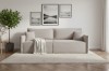 Modernes beiges Sofa im Wohnzimmer mit Wandbildern und Teppich.