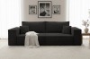 Schwarzes Cordsofa im Wohnzimmer mit hellem Teppich und Wandbildern