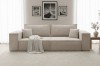 Beiges Cordsofa im gemütlichen Wohnzimmer mit heller Decke