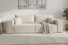 Modernes beiges Sofa aus Bouclé-Stoff in einem hellen, minimalistisch eingerichteten Wohnzimmer.