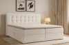 Komfortables weißes Boxspringbett mit gestepptem Kopfteil und Topper in modernem Design.