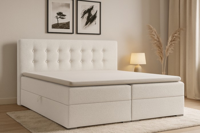 Elegantes Boxspringbett in Beige mit Knopfheftung am Kopfteil in einem gemütlich eingerichteten Schlafzimmer.