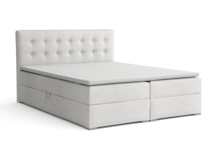Freigestelltes weißes Boxspringbett Cynthia Lux mit abgestepptem Kopfteil und Topper.