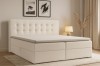 Gemütliches Schlafzimmer mit dem Cynthia Lux Boxspringbett in hellem Bouclé-Stoff und stilvoller Dekoration.