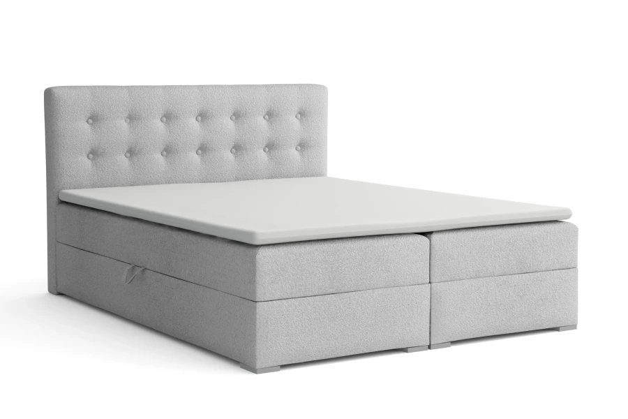 Hellgraues Boxspringbett aus Bouclé-Stoff mit Stauraumfunktion, isoliert.