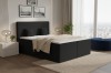 Schwarzes Boxspringbett mit markantem Cord-Bezug in einem luxuriösen Schlafzimmer.