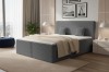 Elegantes Boxspringbett in Dunkelgrau mit Cord-Optik und Kissen in modernem Schlafzimmer.