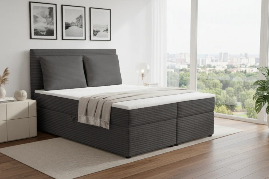 Dunkelgraues Boxspringbett mit Cord-Bezug in einem modernen Zimmer mit Ausblick.