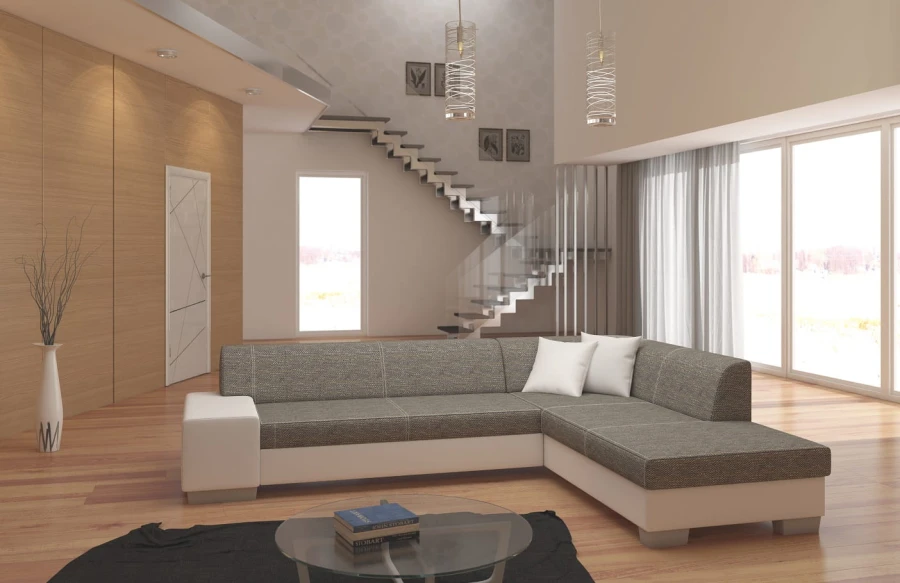Modernes Ecksofa in Grau und Weiß in einem hellen Wohnzimmer mit Treppe