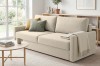 Gemütliches beiges 2-Sitzer Sofa in hellem Wohnzimmer mit Couchtisch und skandinavischem Dekor.