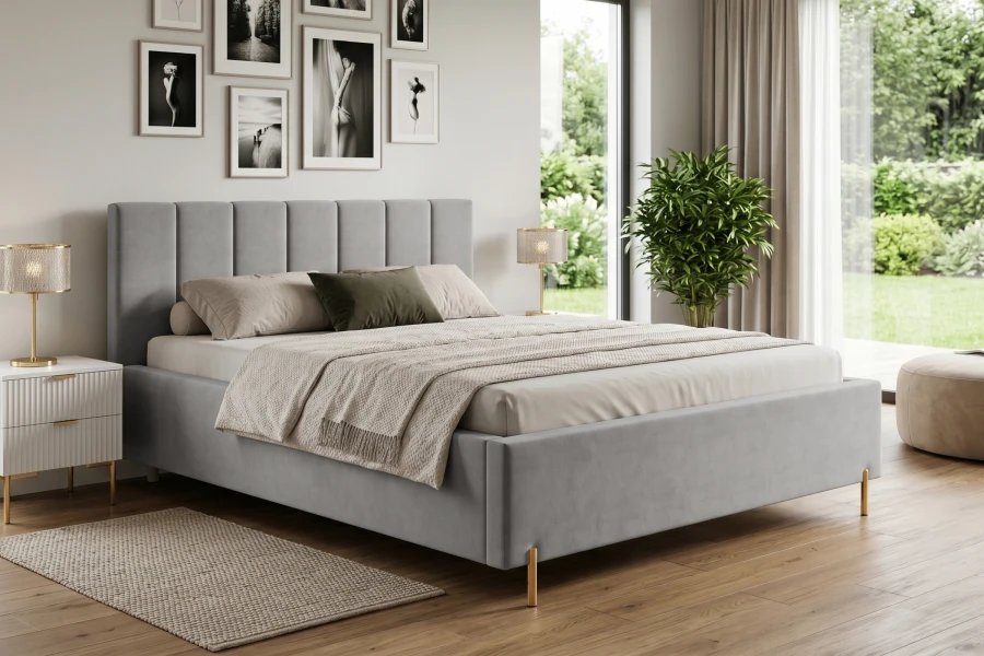 Stilvolles Schlafzimmer mit hellgrauem Polsterbett, goldenen Akzenten und modernen Wandbildern.