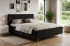 Elegantes schwarzes Polsterbett in einem hellen, modern eingerichteten Schlafzimmer.