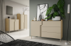 Beige Kommode mit drei Schubladen neben einer Monstera-Pflanze in einem modern eingerichteten Raum.