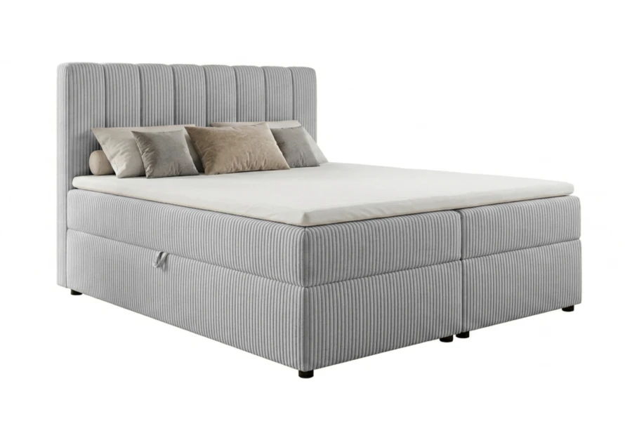 Hellgraues Boxspringbett mit markanter Cord-Struktur und hohem Kopfteil auf weißem Grund.