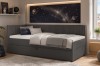Anthrazitfarbenes Boxspringbett mit Kord-Lehne in gemütlichem Jugendzimmer mit Sternen-Wandbild.