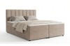 Beiges Boxspringbett mit gepolstertem Kopfteil und Bettwäsche