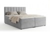 Graues Boxspringbett mit hohem Kopfteil auf weißem Hintergrund