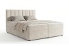Boxspringbett in hellem Beige mit gepolstertem Kopfteil.