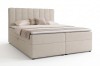 Elegantes beiges Boxspringbett mit gepolstertem Kopfteil und Kissen-Set auf weißem Hintergrund.