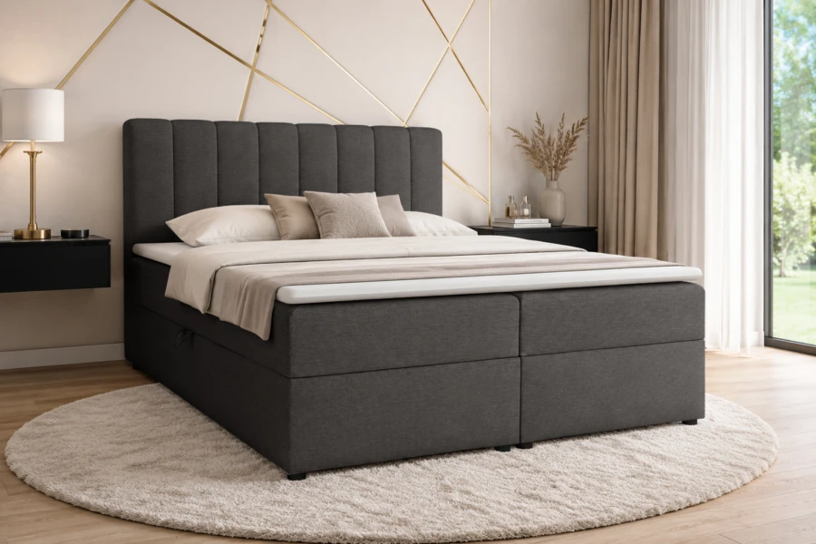 Stilvolles dunkelgraues Boxspringbett in einem modern eingerichteten Schlafzimmer mit rundem Teppich.