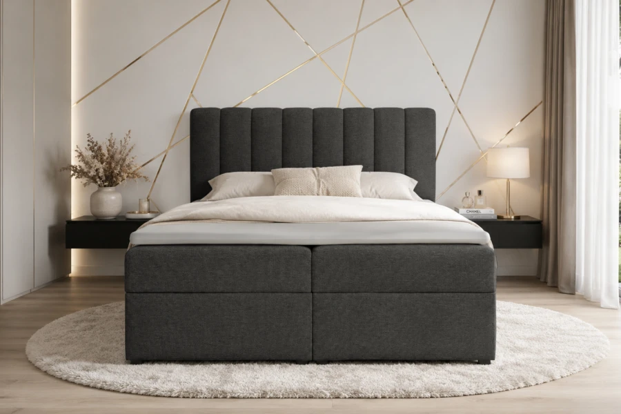 Anthrazitfarbenes Boxspringbett mit vertikal gestepptem Kopfteil in eleganter Schlafzimmerumgebung.
