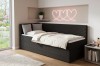 Schwarzes Kindersofa Roberto als gemütliches Bett mit weißer Bettwäsche in modernem Zimmer.